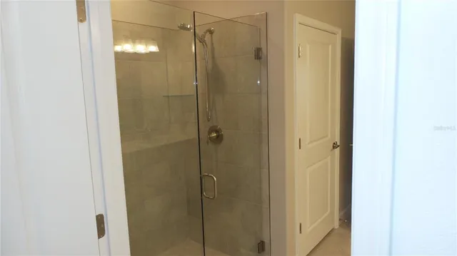 a bathroom with a glass shower door
