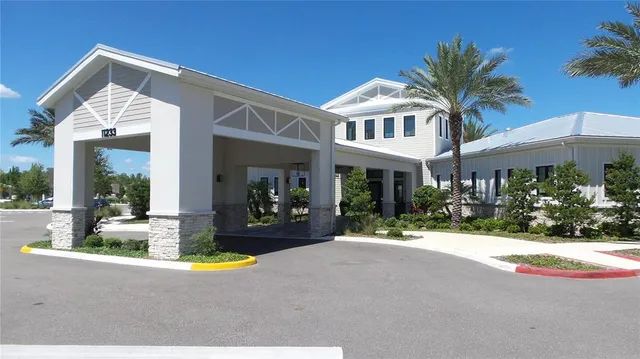 a view of a house with swimming pool and a porch with furniture