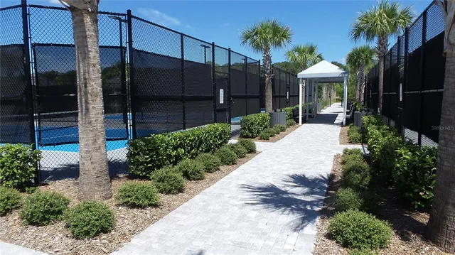 a view of a house with a yard and potted plants