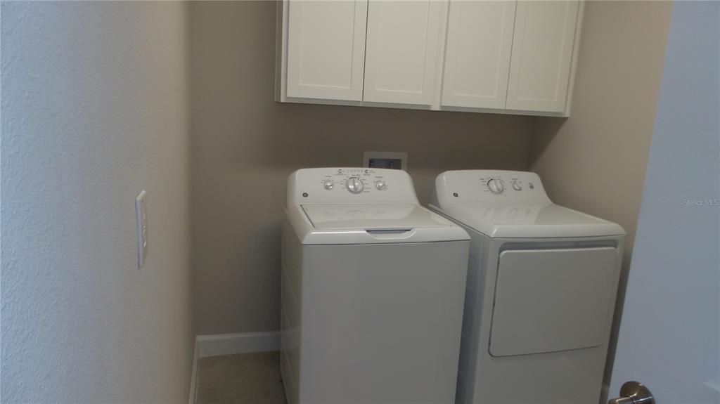 16715 Shell Bay Drive Land O Lakes, FL 34638 - Photo 9 of 19 a utility room with dryer and washer