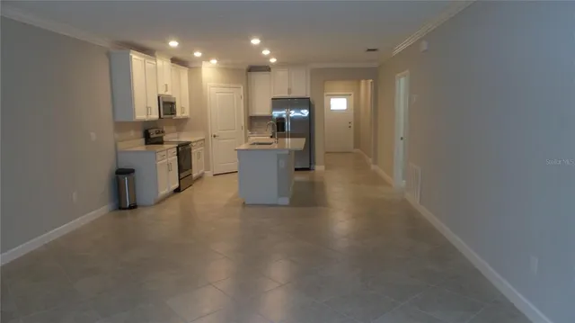 a view of a kitchen with microwave and cabinets