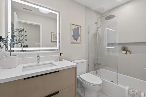 a bathroom with a sink toilet and shower