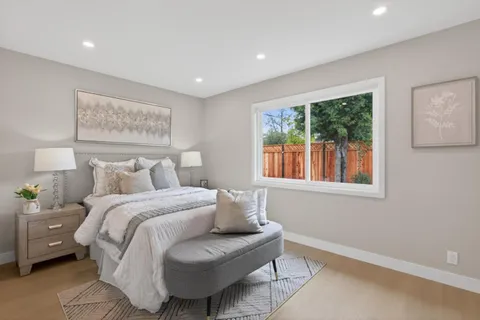 a spacious bedroom with a bed and a window