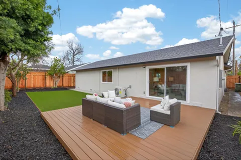 a living room with furniture and a garden
