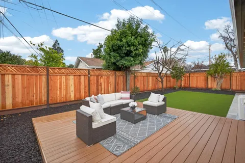 a backyard of a house with table and chairs