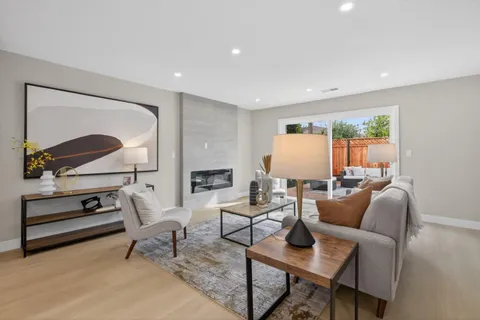 a living room with furniture a rug and a lamp
