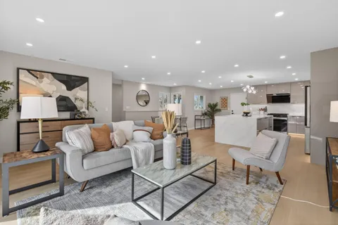 a living room with furniture and kitchen view