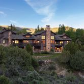 an aerial view of multiple houses with a big yard