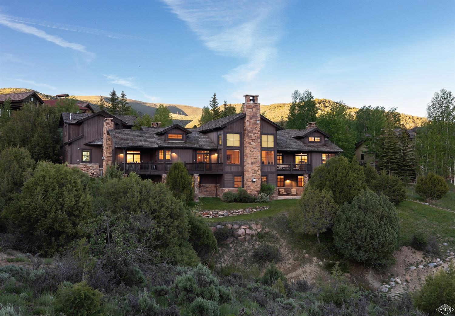 an aerial view of multiple houses with a big yard
