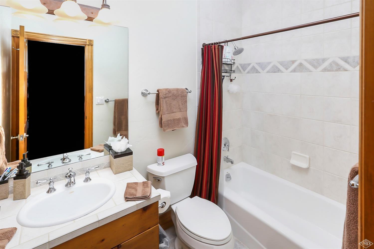 142 Spring Creek Lane Edwards, CO 81632 - Photo 16 of 25 a white toilet sitting next to a bathroom sink