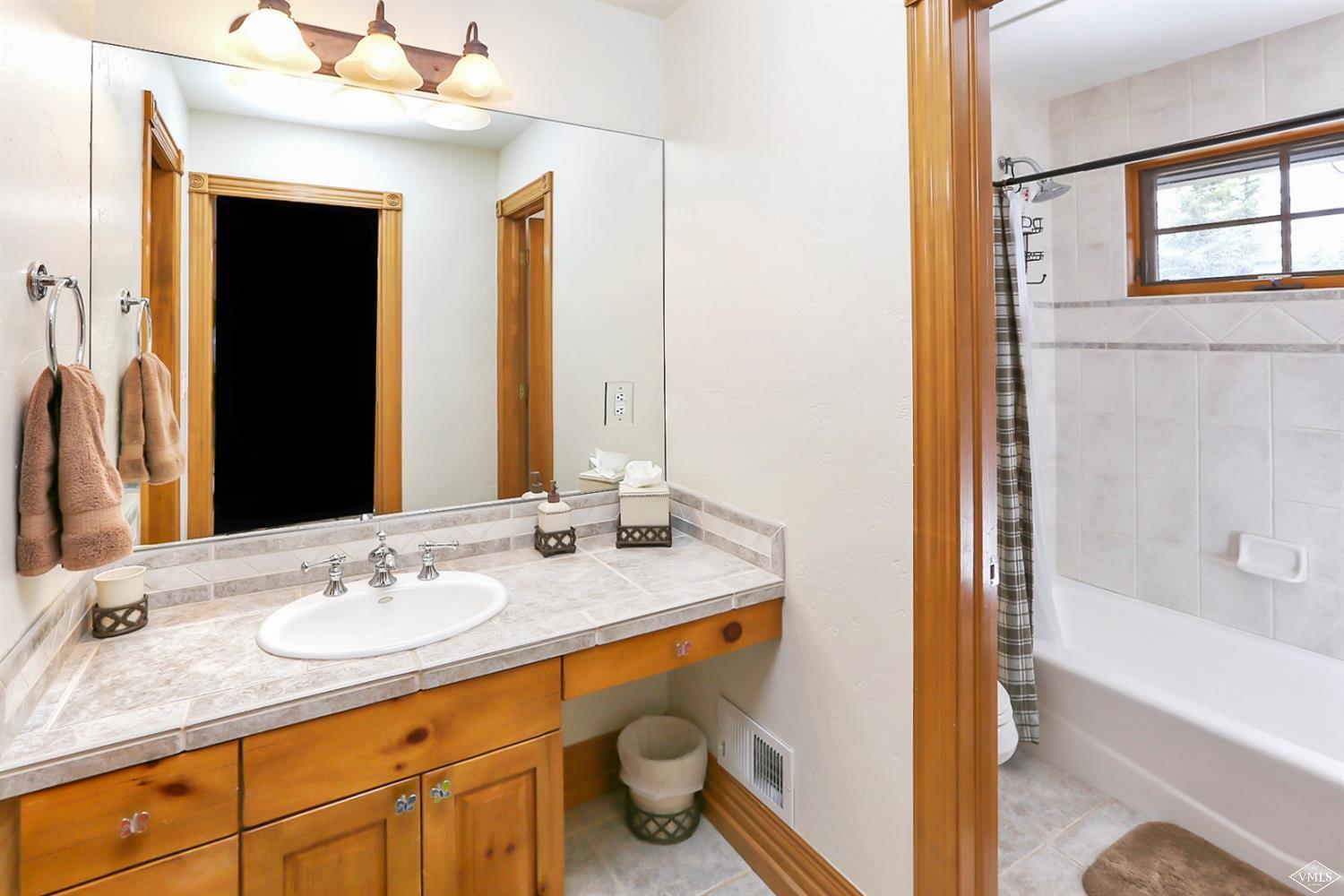 142 Spring Creek Lane Edwards, CO 81632 - Photo 18 of 25 a bathroom with a granite countertop sink and a mirror