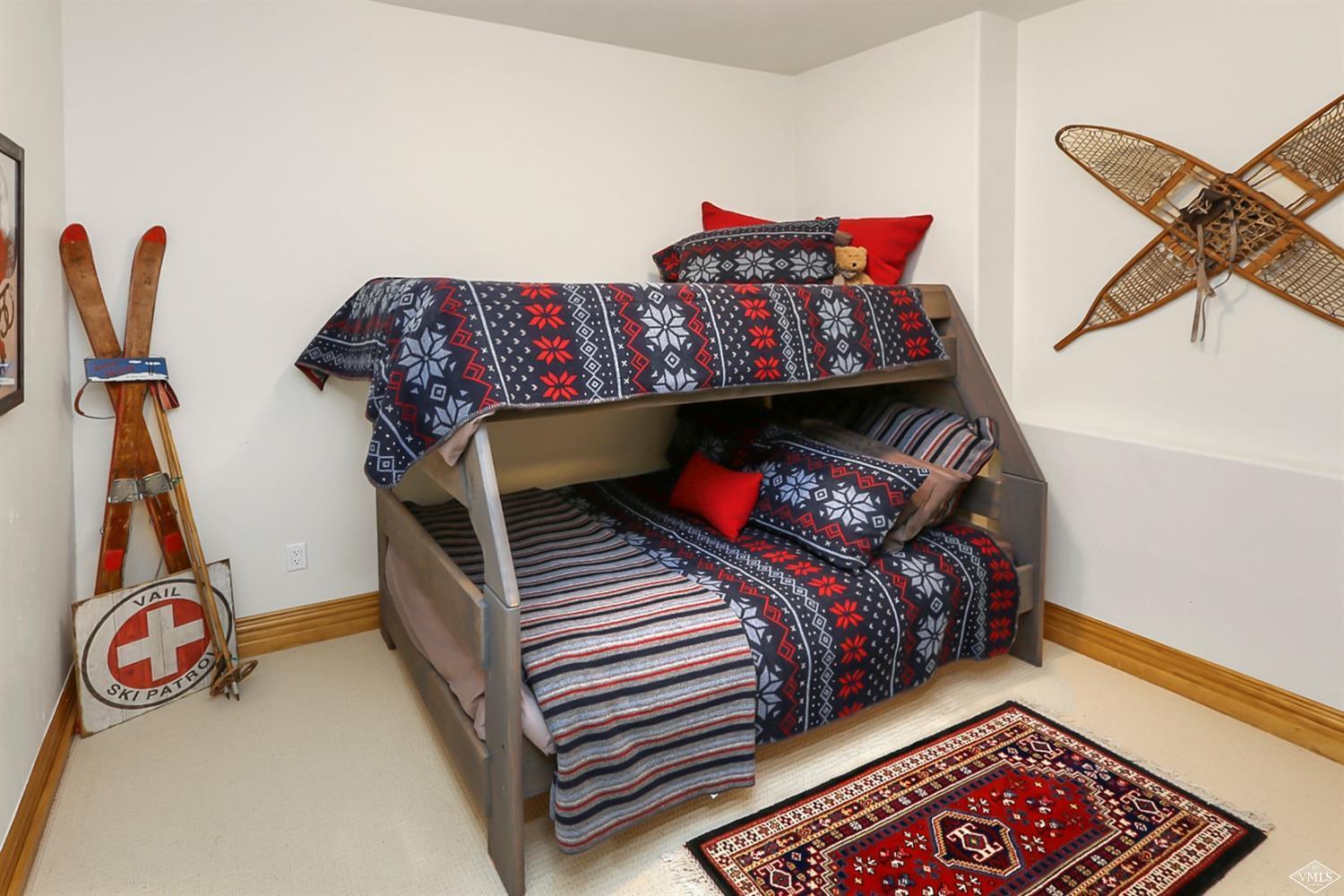 142 Spring Creek Lane Edwards, CO 81632 - Photo 20 of 25 a bedroom with bed and a chandelier