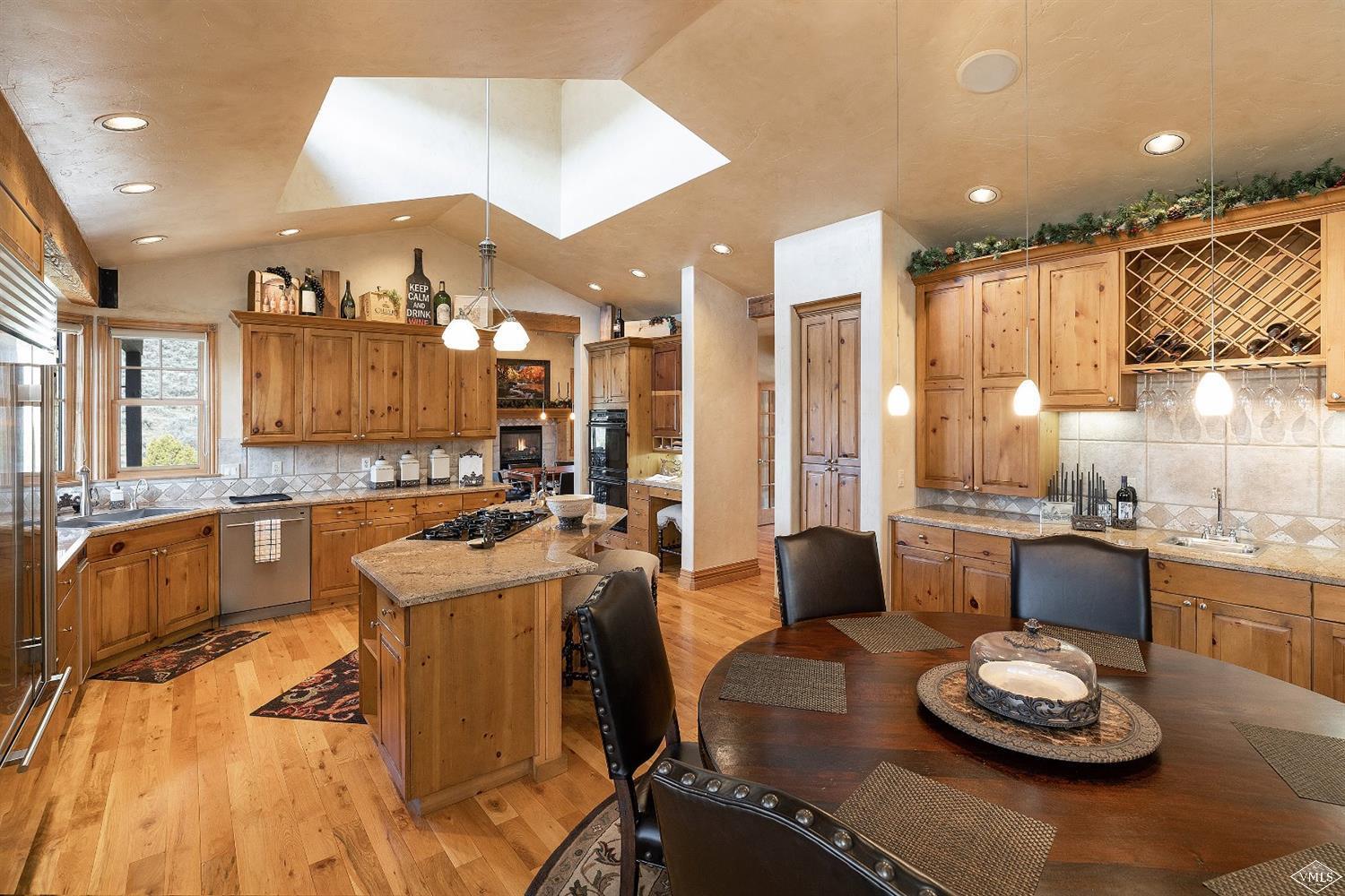 142 Spring Creek Lane Edwards, CO 81632 - Photo 6 of 25 a large kitchen with a table and chairs
