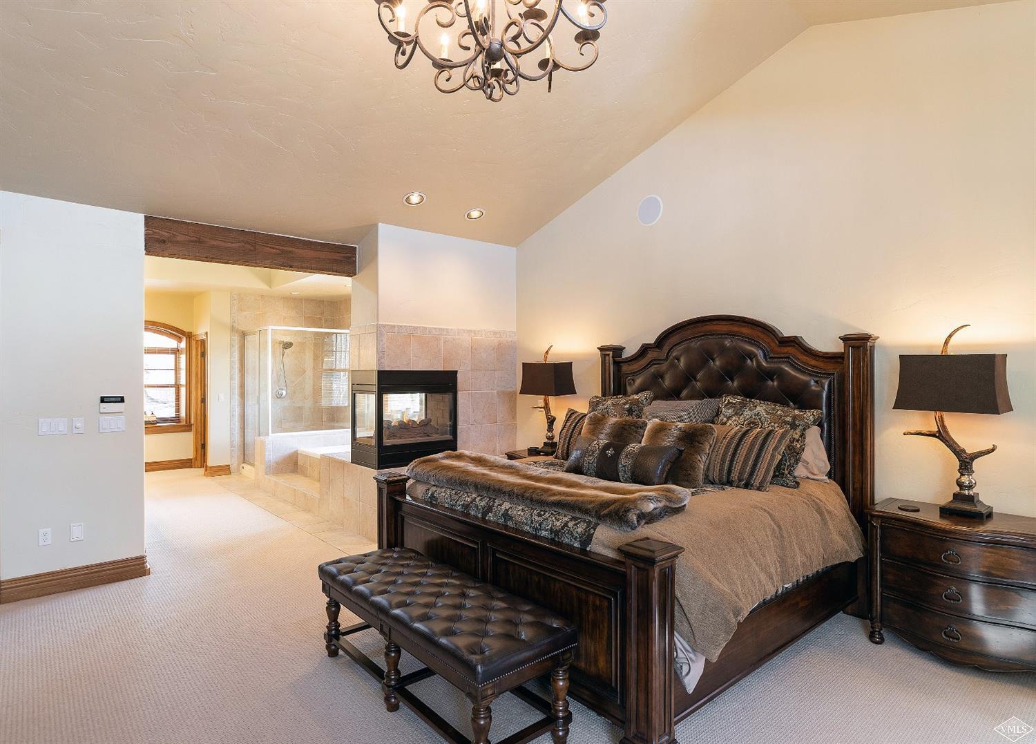 142 Spring Creek Lane Edwards, CO 81632 - Photo 9 of 25 a bedroom with a bed furniture and a fireplace