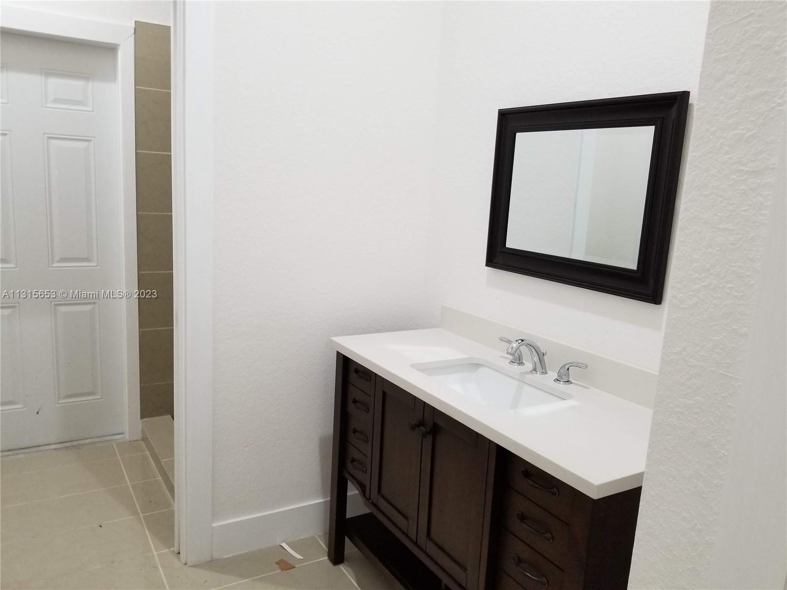 Goulds Miami, FL 33170 - Photo 2 of 5 a bathroom with a sink and a mirror