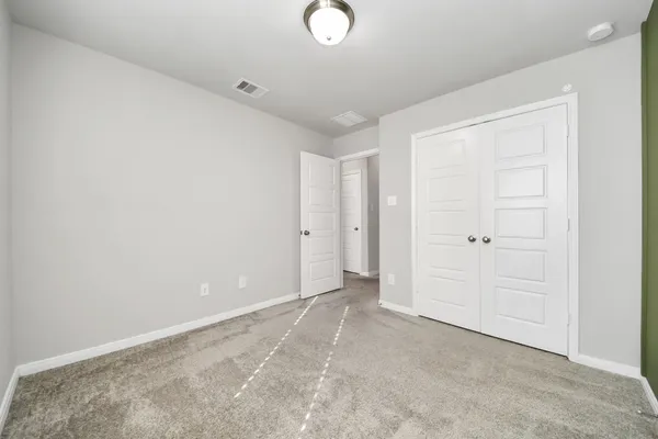 an empty room with closet area