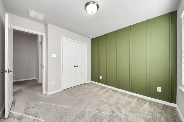 a view of an empty room with closet area
