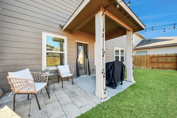 a view of two chairs in the backyard