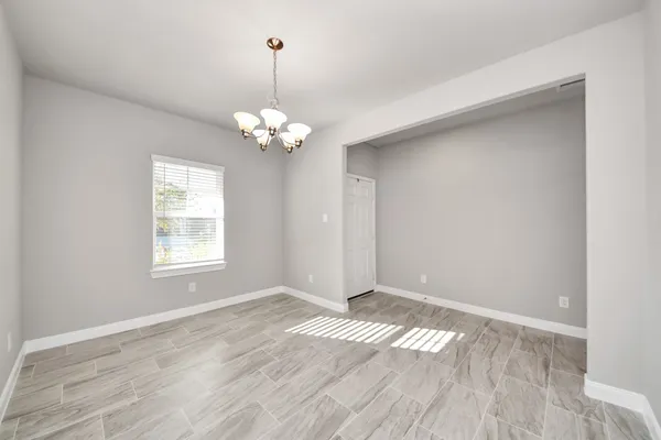 a view of empty room with wooden floor and window