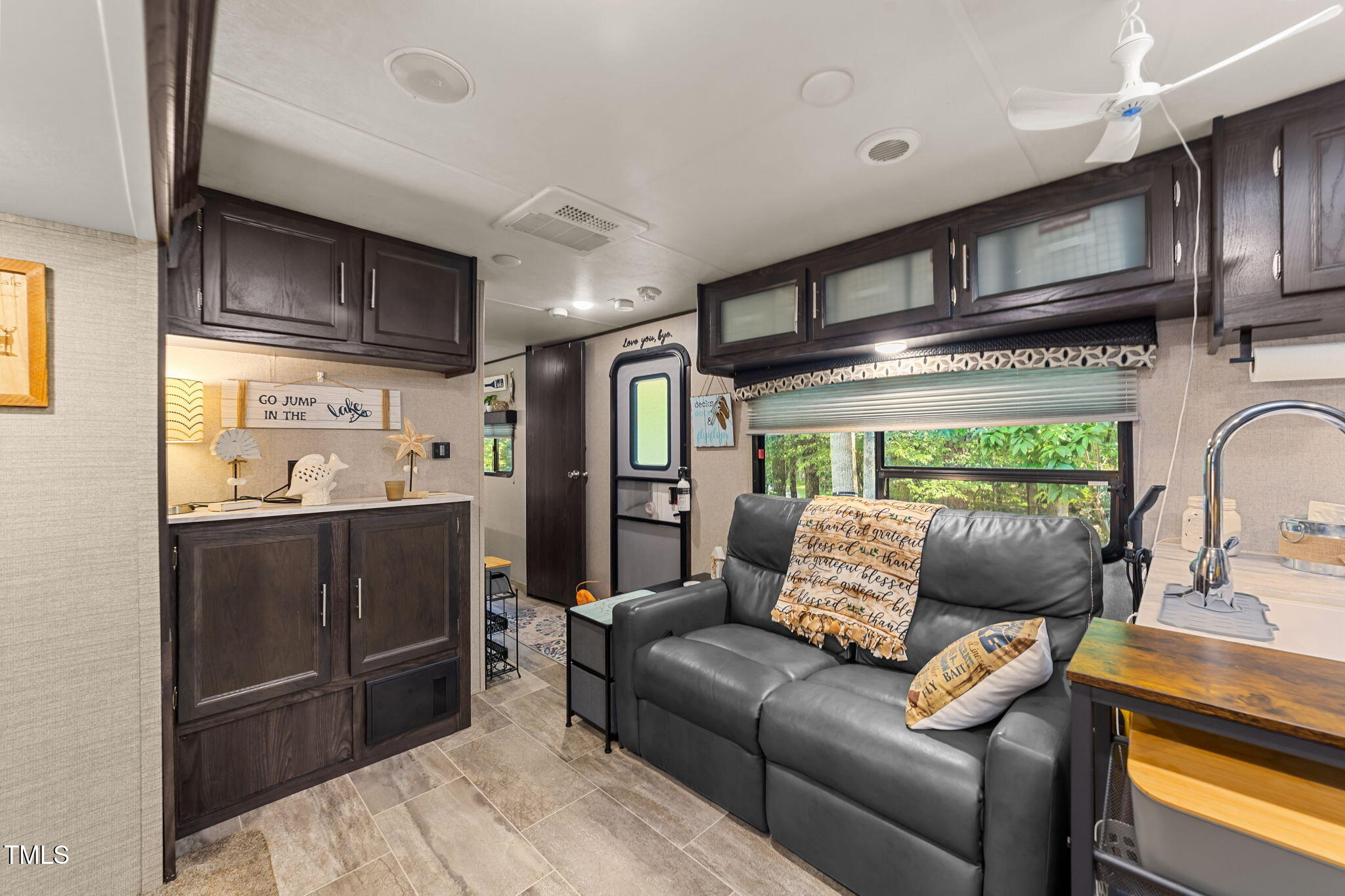 171 Winnebago Loop Louisburg, NC 27549 - Photo 22 of 32 a living room with stainless steel appliances furniture and a kitchen view