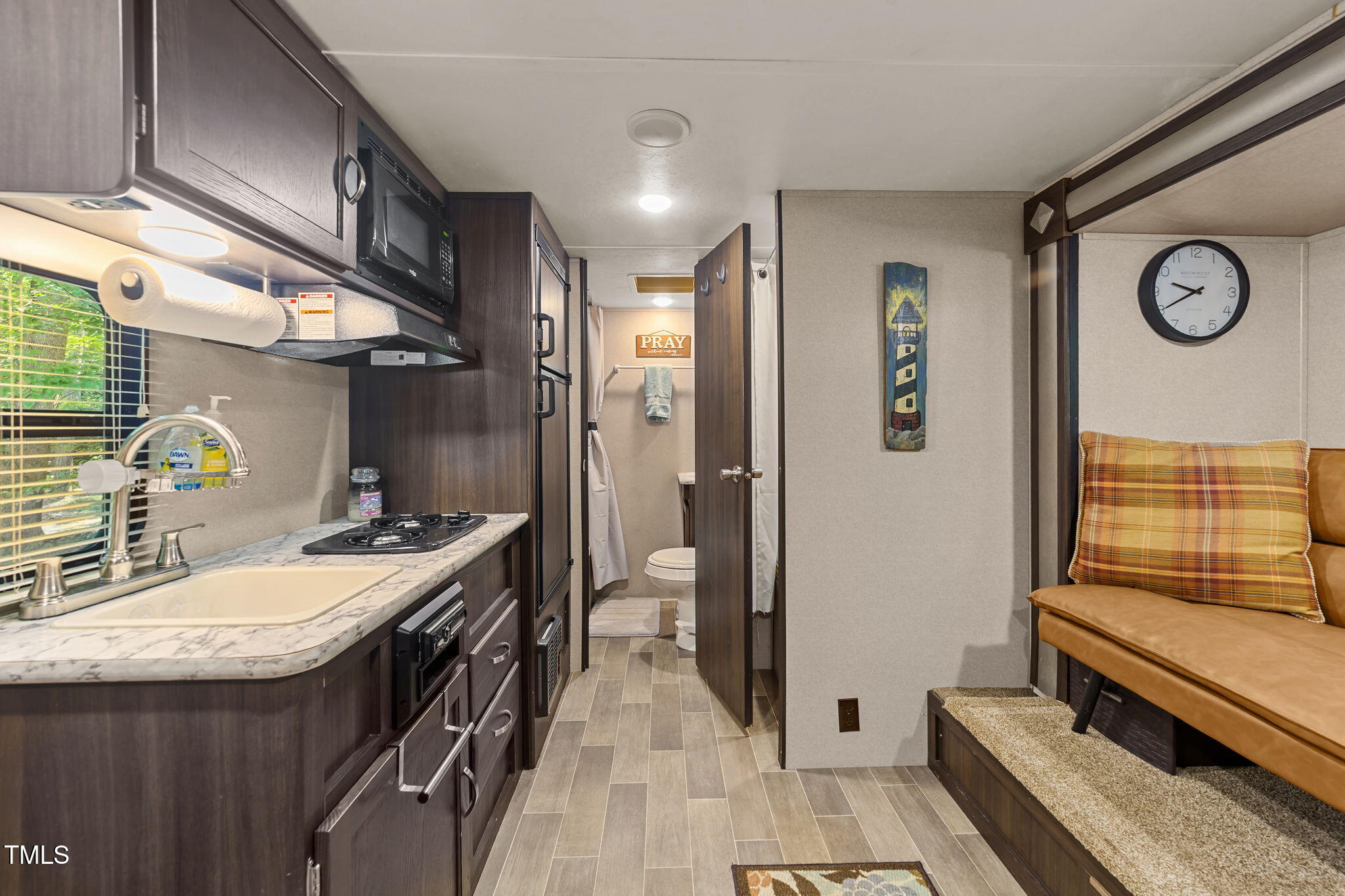 171 Winnebago Loop Louisburg, NC 27549 - Photo 26 of 32 a bathroom with a sink a mirror and a shower