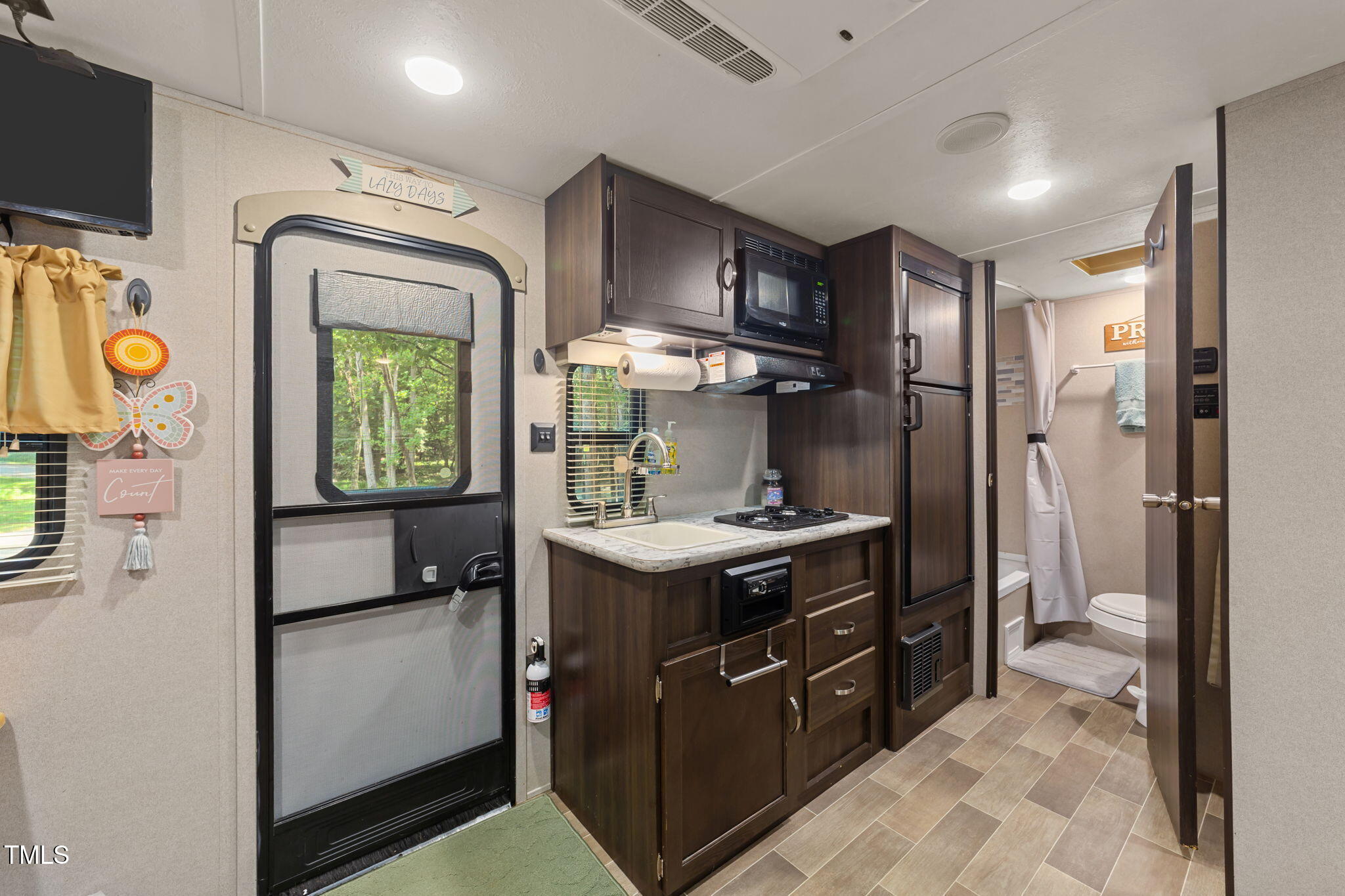 171 Winnebago Loop Louisburg, NC 27549 - Photo 27 of 32 a kitchen with stainless steel appliances granite countertop a stove a refrigerator and a stove