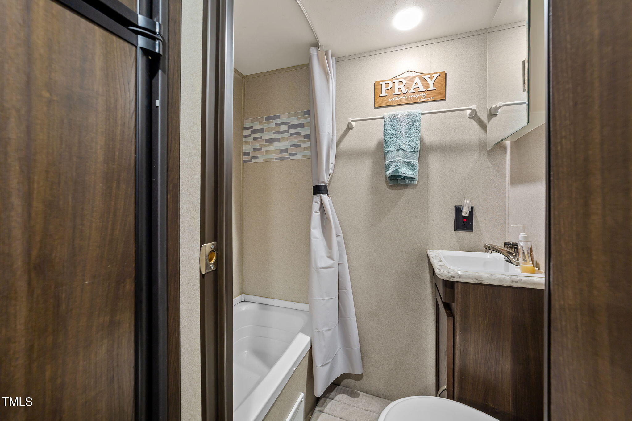 171 Winnebago Loop Louisburg, NC 27549 - Photo 31 of 32 a bathroom with a sink mirror and toilet