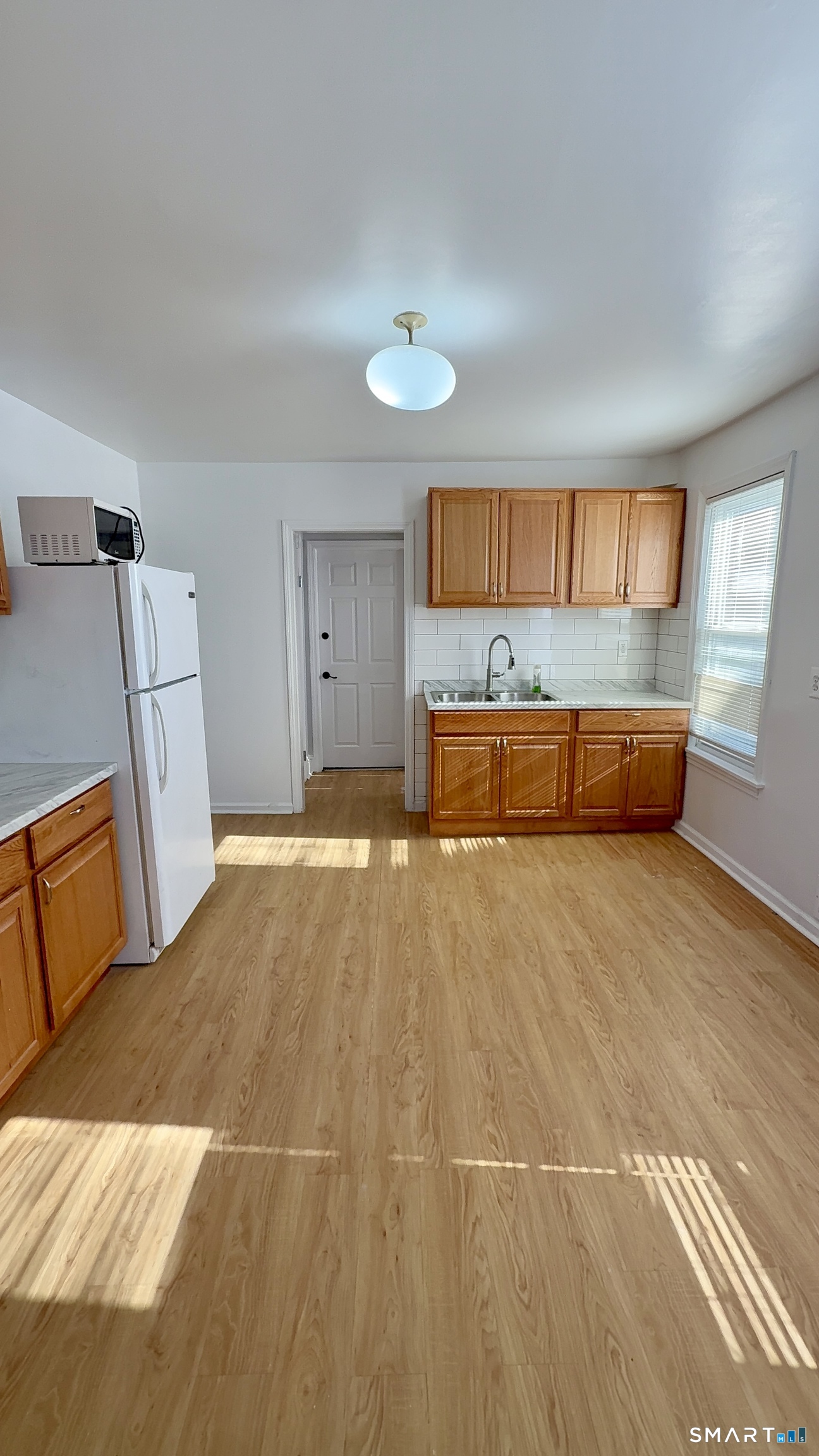 168 Alfred Street, Unit 1 Bridgeport, CT 06605 - Photo 2 of 14 a spacious bedroom with a bed and wooden floor