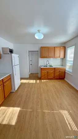 a spacious bedroom with a bed and wooden floor