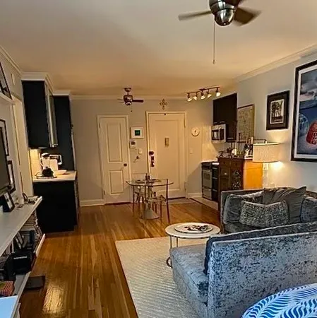 a front view of a house with a yard and tree s