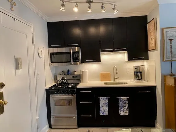 a stove top oven sitting inside of a kitchen