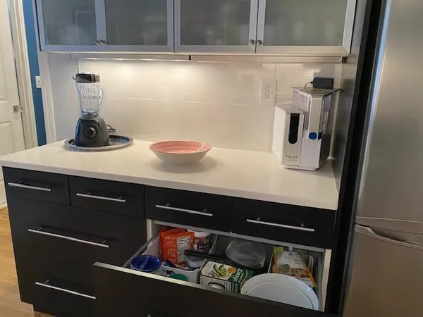 a kitchen with stainless steel appliances kitchen island granite countertop a sink and cabinets