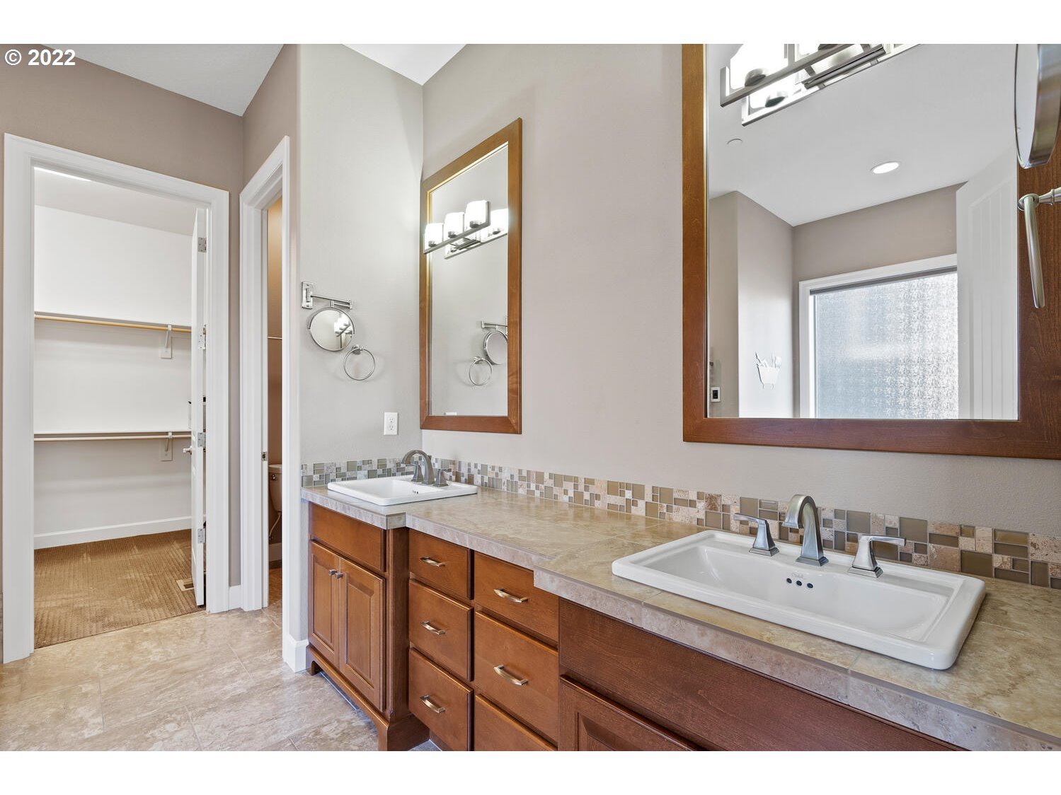 6117 Southwest 67th Place Portland, OR 97223 - Photo 15 of 32 a bathroom with a sink double vanity granite tub shower and a mirror