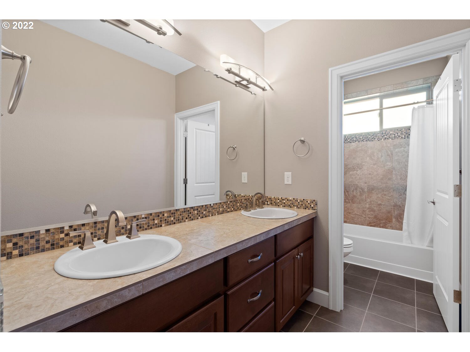 6117 Southwest 67th Place Portland, OR 97223 - Photo 26 of 32 a bathroom with a sink and a mirror