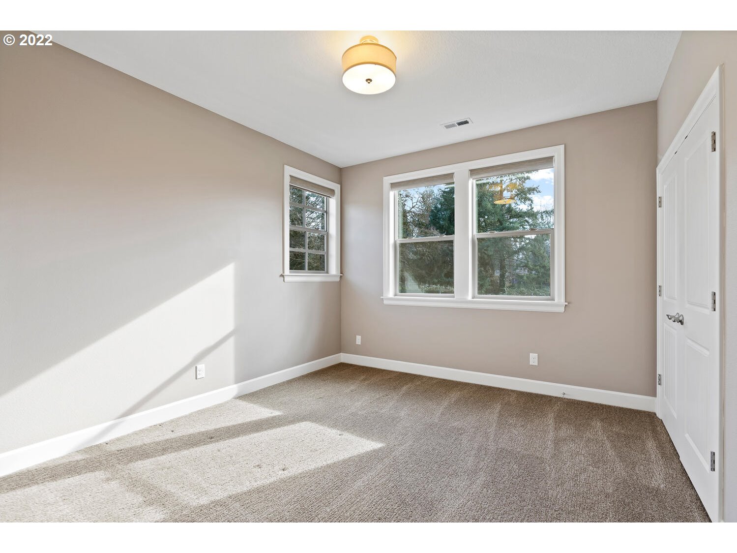 6117 Southwest 67th Place Portland, OR 97223 - Photo 27 of 32 a view of an empty room with wooden floor and window