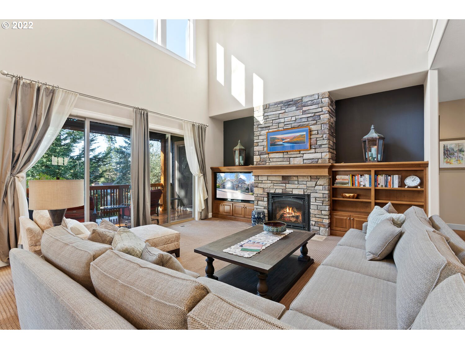 6117 Southwest 67th Place Portland, OR 97223 - Photo 4 of 32 a living room with furniture a fireplace and a large window