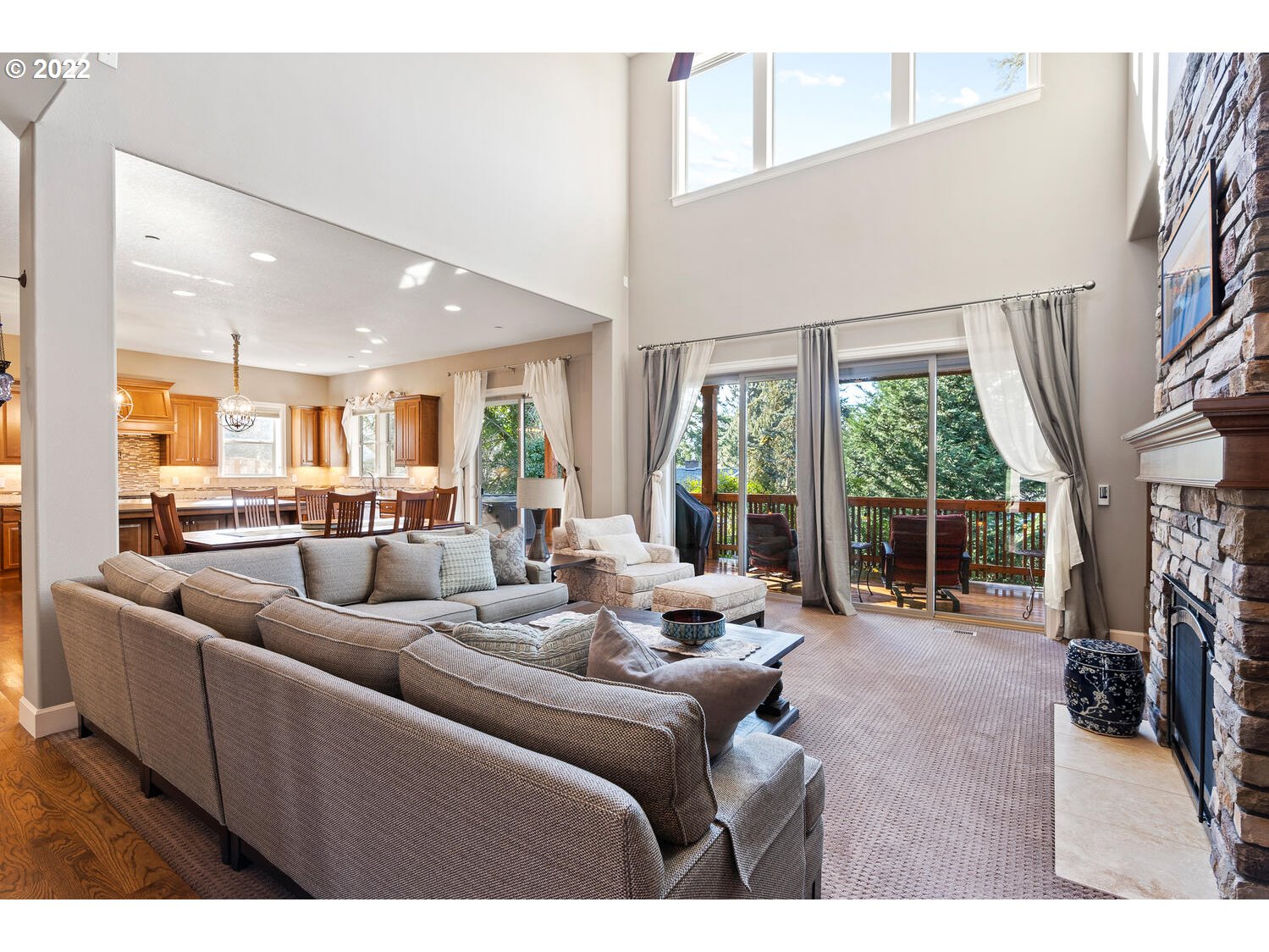 6117 Southwest 67th Place Portland, OR 97223 - Photo 5 of 32 a living room with furniture floor to ceiling window and a flat screen tv