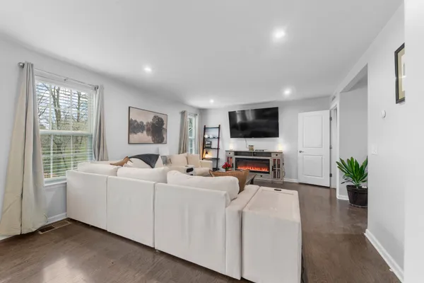 a dining room with furniture and a kitchen view