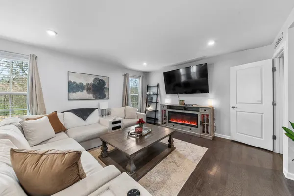 a bedroom with a bed window and a flat screen tv