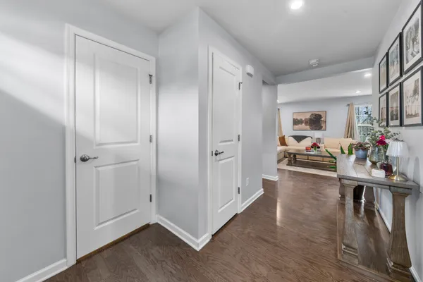 a view of a hallway with closet and wooden floor