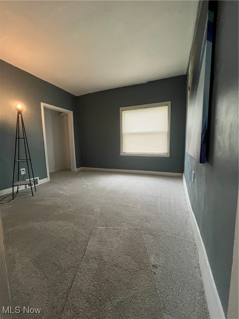 1264 Diagonal Road Akron, OH 44320 - Photo 11 of 23 Unfurnished bedroom with carpet, baseboards, and a closet