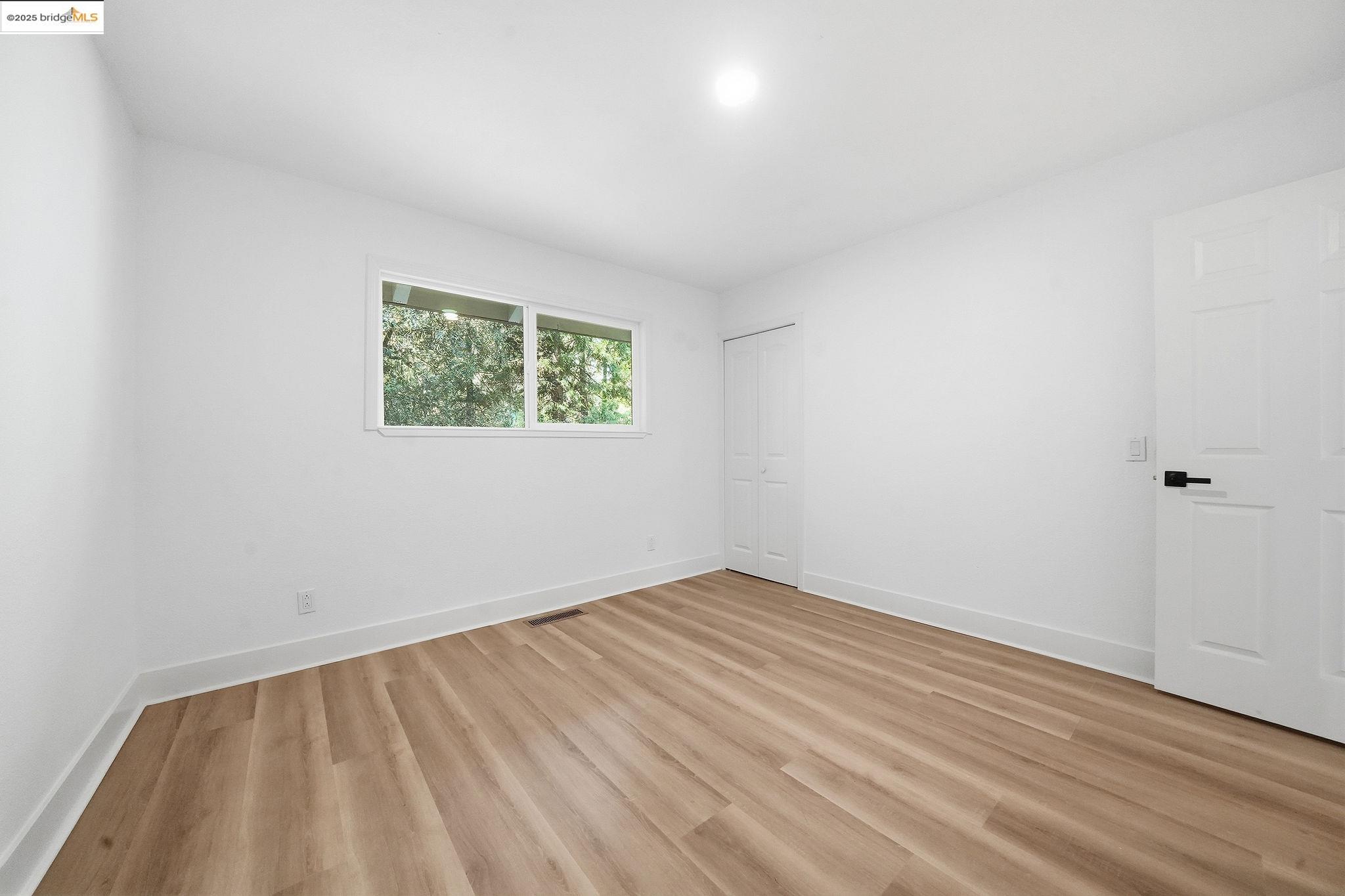 23656 Lightning Pioneer, CA 95666 - Photo 15 of 32 a view of an empty room with wooden floor and a window