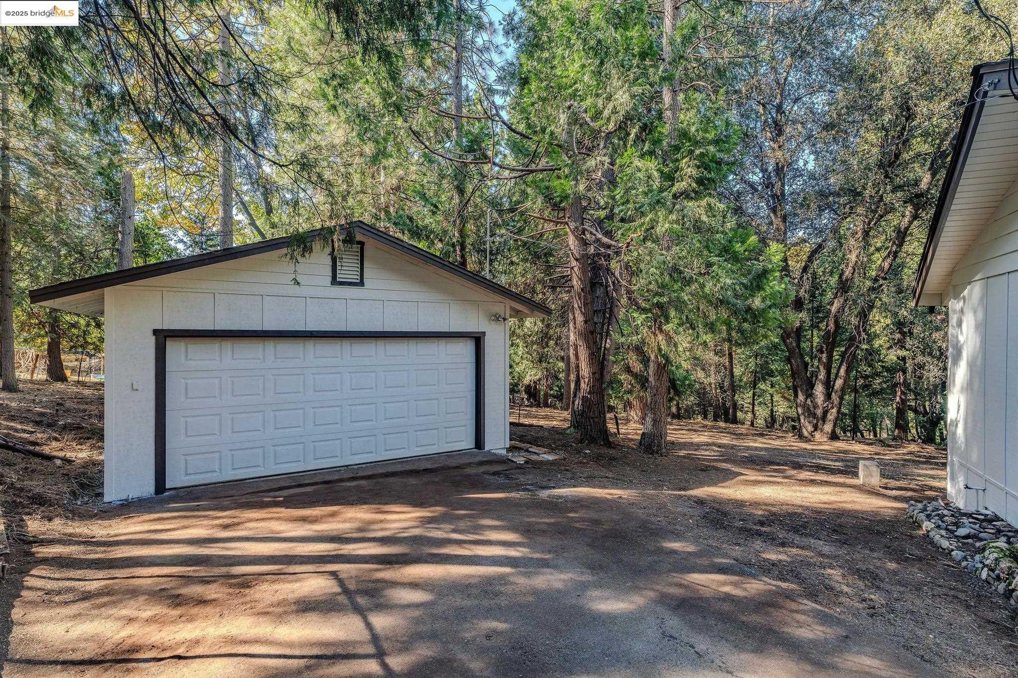 23656 Lightning Pioneer, CA 95666 - Photo 24 of 32 a front view of a house with a yard and garage