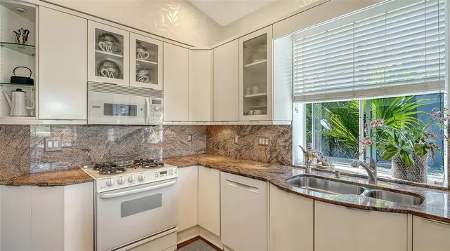a kitchen with sink and large window