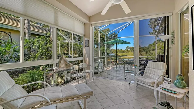 a view of a patio with a table and chairs under an umbrella