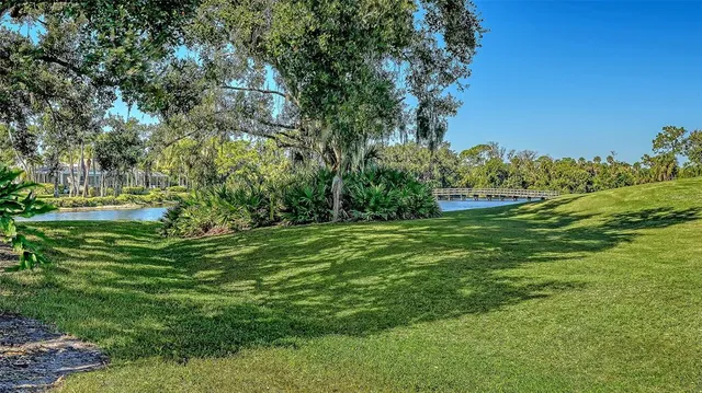 an aerial view of a house with a yard and lake view