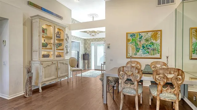 a kitchen with stainless steel appliances granite countertop a sink a stove a refrigerator a washer dryer and dining table