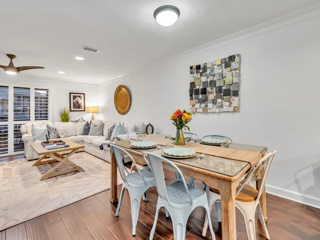 a living room with furniture and flower pot