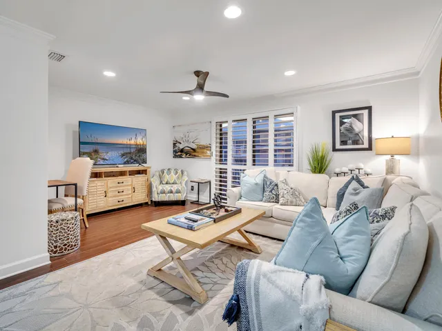 a dining room with furniture kitchen view and wooden floor