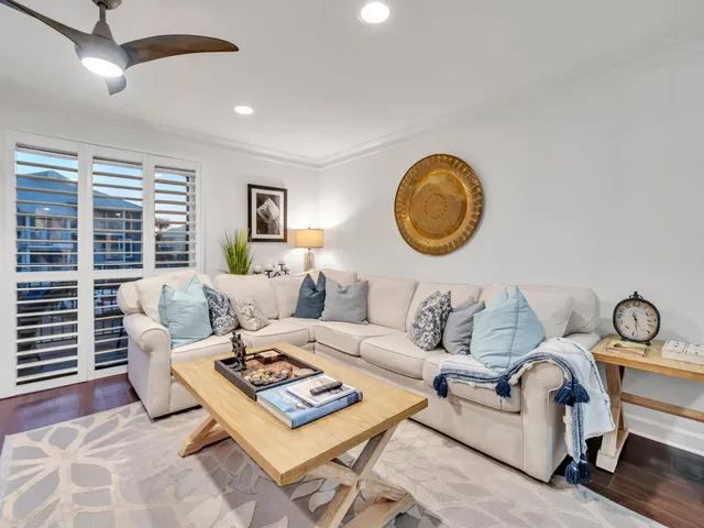 a living room with furniture a rug and a table